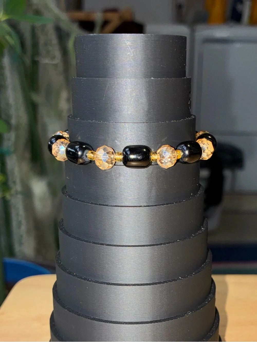 Black and Gold Beaded Stretch Bracelet with Iridescent Flower Charm - Picture 6 of 9